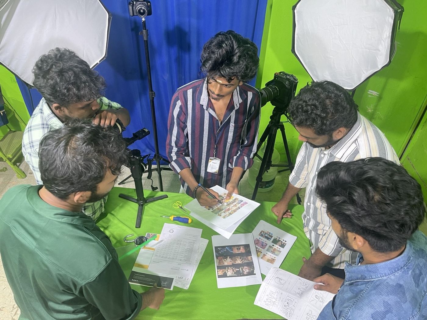 Crew planning shots on the green-screen set